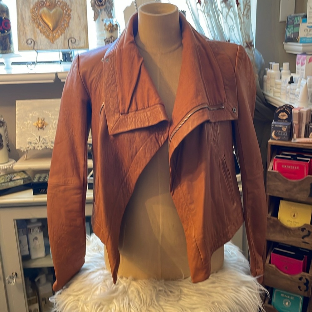 Women’s rust color leather jacket with labels